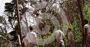 Military troops climbing a net during obstacle course 4k