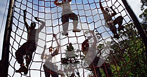 Military troops climbing a net during obstacle course 4k