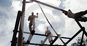 Military troops climbing rope during obstacle course 4k