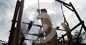 Military troops climbing rope during obstacle course 4k