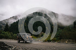 Military truck of The Defense Forces in evergreen Forest in winter, Racha, Georgia