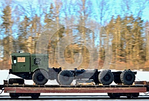 Military truck tractor on a railway platform. photo