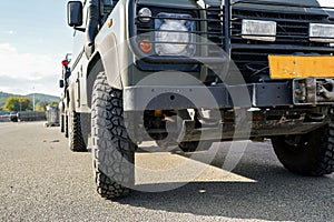 Military truck vehicle, low angle detail to wheels and front light only