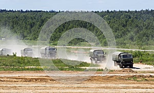 Military trucks go on a dirt road