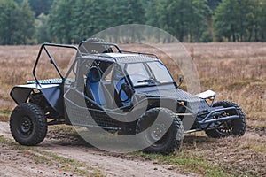 Military vehicle Buggy made by hand. A car for off-road and mud. Outdoors, dirt road