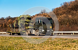 Military vehicle with caterpillar wheels caried by a truck