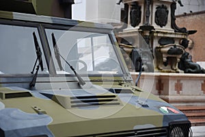 Military vehicle stationed in square in Bologna for security. Neptune statue on the background. Bologna, Italy
