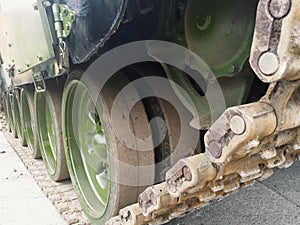 Military vehicles running gear on tracked chassis on asphalt