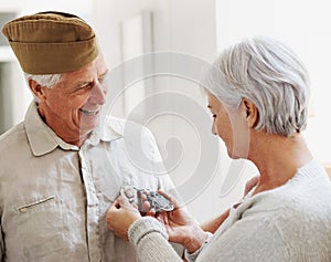 Military veteran, man and woman with medal, uniform and smile together with memory, pride and success. Elderly couple
