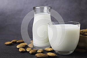Milk with almonds nut on dark background copy space organic healthy concept