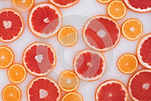 Milk bath with grapefruit and oranges slices. Top view. Flat lay.