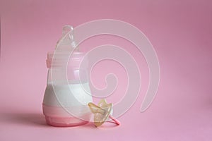 Milk bottle baby and Pacifier on pink background. place for te