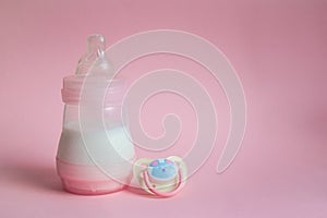 Milk bottle baby and Pacifier on pink background. place for te