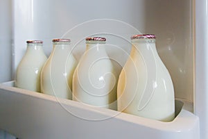 Milk Bottles in Fridge Door