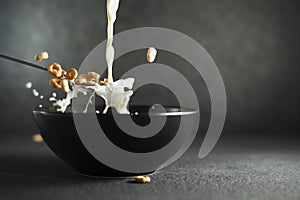 Milk and cereal splashing out of spoon