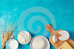 Milk and cheese, dairy products on wooden blue background. Jewish holiday Shavuot concept.