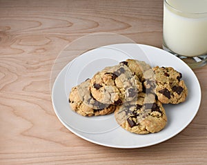Milk and Chocolate Chip or Chunk Cookies on wood table