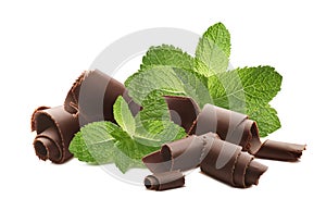 Milk chocolate curls and mint leaves isolated on white background