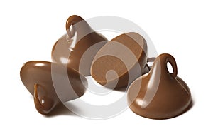 Milk chocolate drops or chips isolated on white background