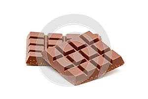 Milk chocolate pieces isolated on white background
