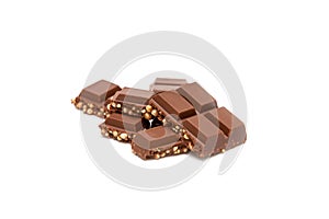 Milk chocolate pieces isolated on white background