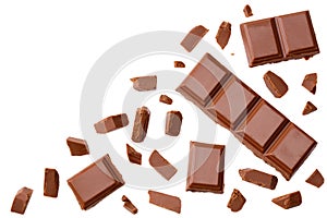 Milk chocolate pieces isolated on white background. top view