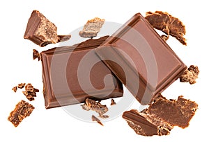 Milk chocolate pieces isolated on white background from top view