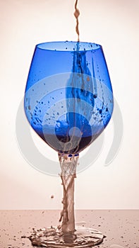 Milk cocktail pouring into a blue glass