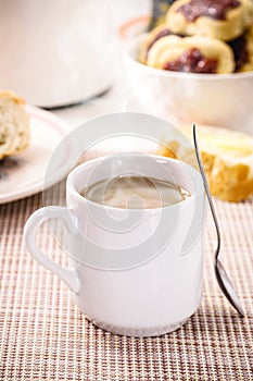 Milk with coffee, traditional Brazilian breakfast drink, served hot, smoking, steaming hot, with bread and toast