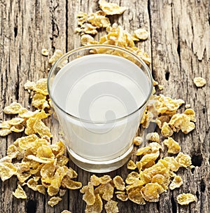 Milk and cornflake on table wooden background