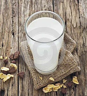 Milk and cornflake on wooden table background