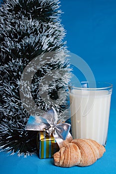 Milk,croissants,souvenir near tree of Christmas