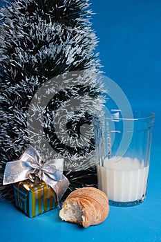 Milk,croissants,souvenir near tree of Christmas