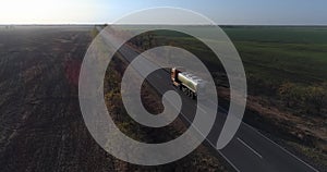 milk delivery, aerial top view of tank truck leaves the farm and drives along road to customers