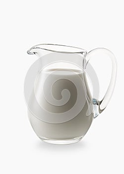 Milk. Glass jug of fresh milk on white background