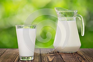 Milk in glass and jug on table