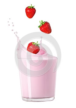 Milk in glass with splash and strawberry