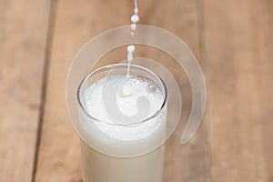 Milk. Image of Milk fall into glass.