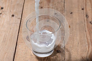 Milk. Image of Milk fall into glass.