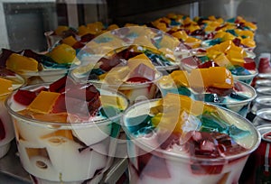 Milk jelly bowl in plastic cups in fridge display