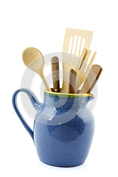 Milk jug filled with kitchen utensils