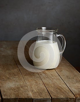 Milk jug on wooden table