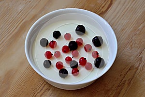 Milk mousse with black and red currant berries