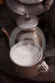 Milk mug and old teapot and kettle in a kyrgyz yurt kitchen