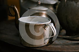 Milk mug and old teapot and kettle in a kyrgyz yurt kitchen