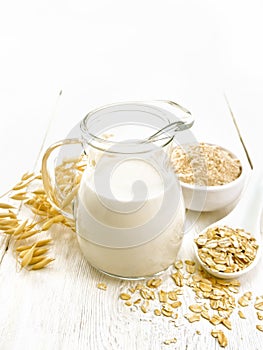 Milk oatmeal in jug on white board