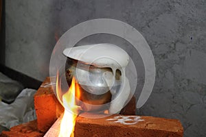 Milk is overflowing on a brick stove due to excess boiling as a tradition in India for house warming ceremony