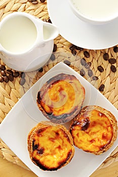 Milk and pasteis de nata, typical Portuguese egg tart pastries