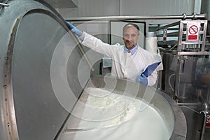 Dairy Plant Food Technologist Checking Milk Pasteurization Process photo