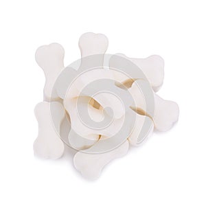 Milk pellet in the shape of a bone on white background.